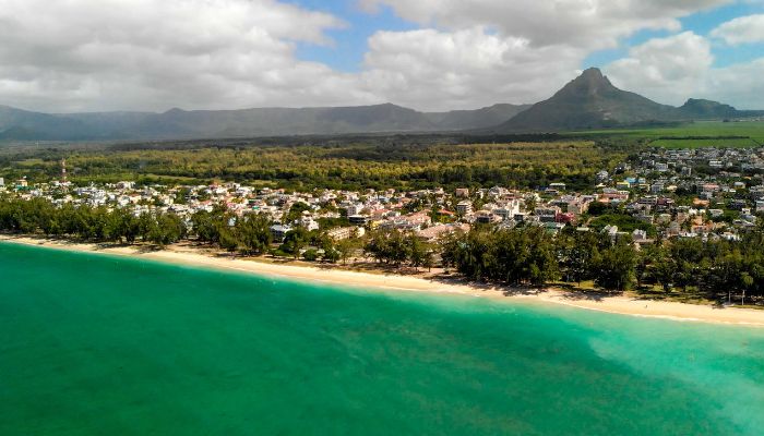 Flic En Flac Beach in Mauritius, boasting the longest stretch of sandy coastline with turquoise waters and palm trees