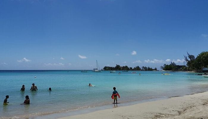 Pereybere in Mauritius, a vibrant hub for water sports enthusiasts, with clear turquoise waters and people engaging in various activities