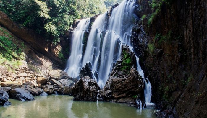 Sathodi Falls, a breathtaking cascade nestled in Karnataka's wilderness, offering a picturesque view of cascading waters against lush greenery