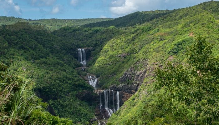 Tamarind Waterfalls in Mauritius, a scenic marvel with cascading waters amidst lush greenery and rocky terrain