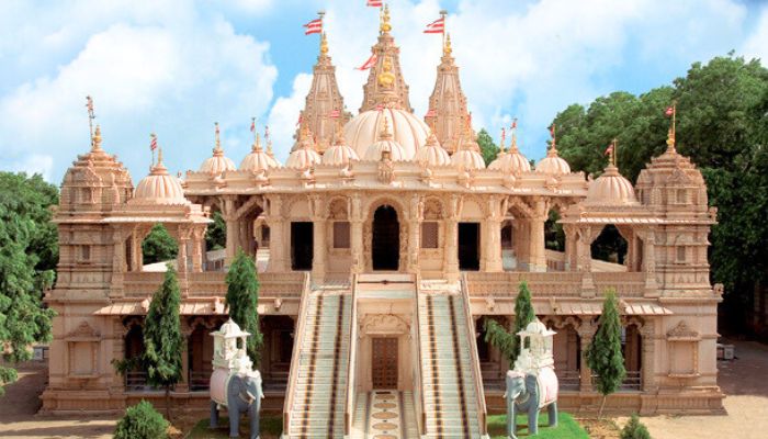 A magnificent view of Baps Shri Swaminarayan Mandir, showcasing its grand white marble structure with intricate carvings and domes