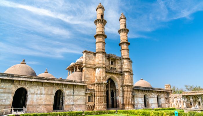 An ancient ruin in Champaner-Pavagadh Archaeological Park, surrounded by greenery and showcasing historic Indo-Islamic architecture