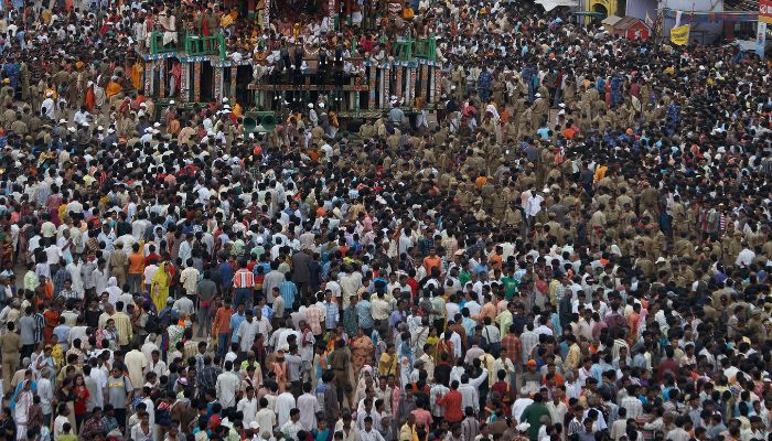 Devotees pull large, decorated chariots through the streets of Ahmedabad during the Rath Yatra festival