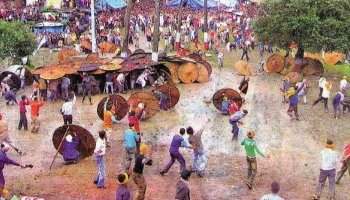 A lively scene at Bhadrapurnima Fair with people enjoying colorful stalls and traditional performances