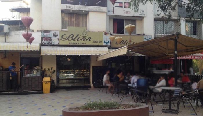 A couple sharing a dessert at an elegant table in Café Bliss, Vadodara.