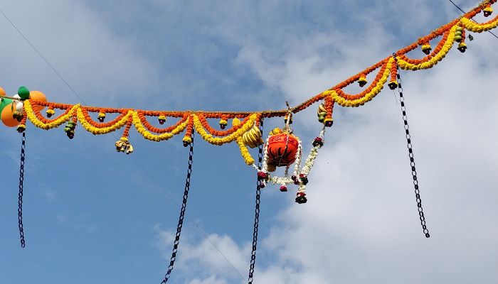 Devotees gather at a temple, celebrating Janmashtami with prayers, decorations, and rituals in honor of Lord Krishna's birth