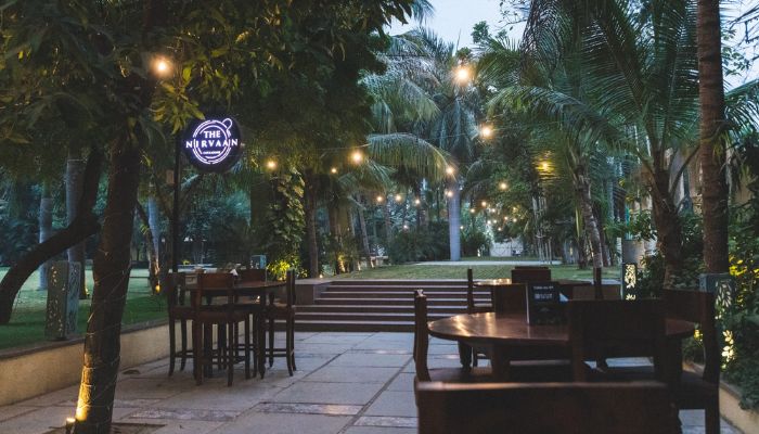 A couple sharing a quiet moment over coffee at Nirvaan Cafe in Vadodara, with serene decor.