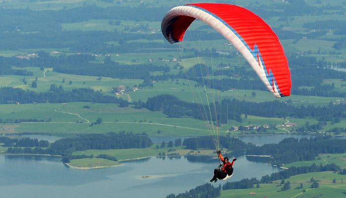 Paragliders soar through the sky over scenic landscapes at the Paragliding Festival