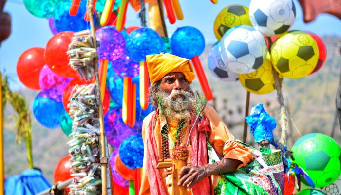 Colorful Bhavnath Fair with a traditionally dressed man and vibrant decorations