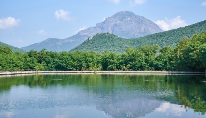 Serene lake with Mount Girnar in the background